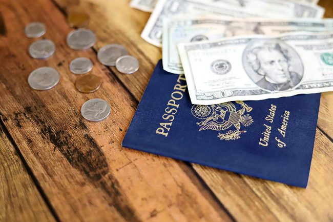 American passport and US dollars and coins